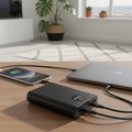 Ultra-realistic 20000mAh power bank charging smartphone and laptop in South African home